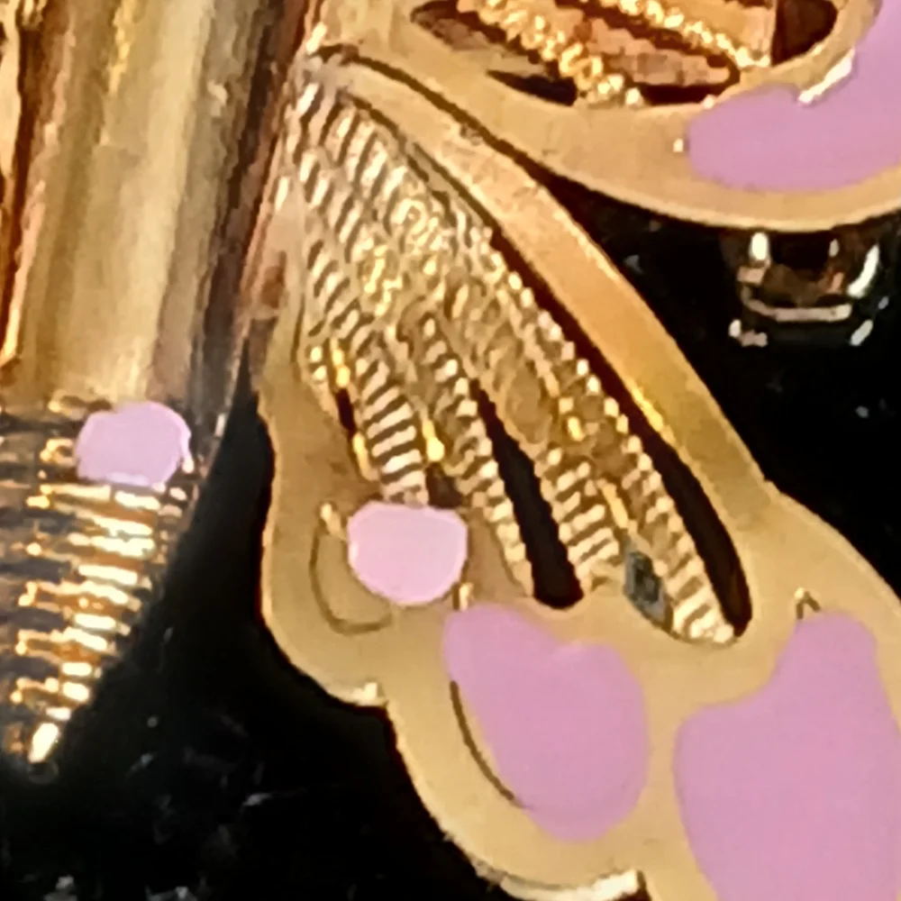 Vintage goldtone filigree butterfly brooch with pink accents